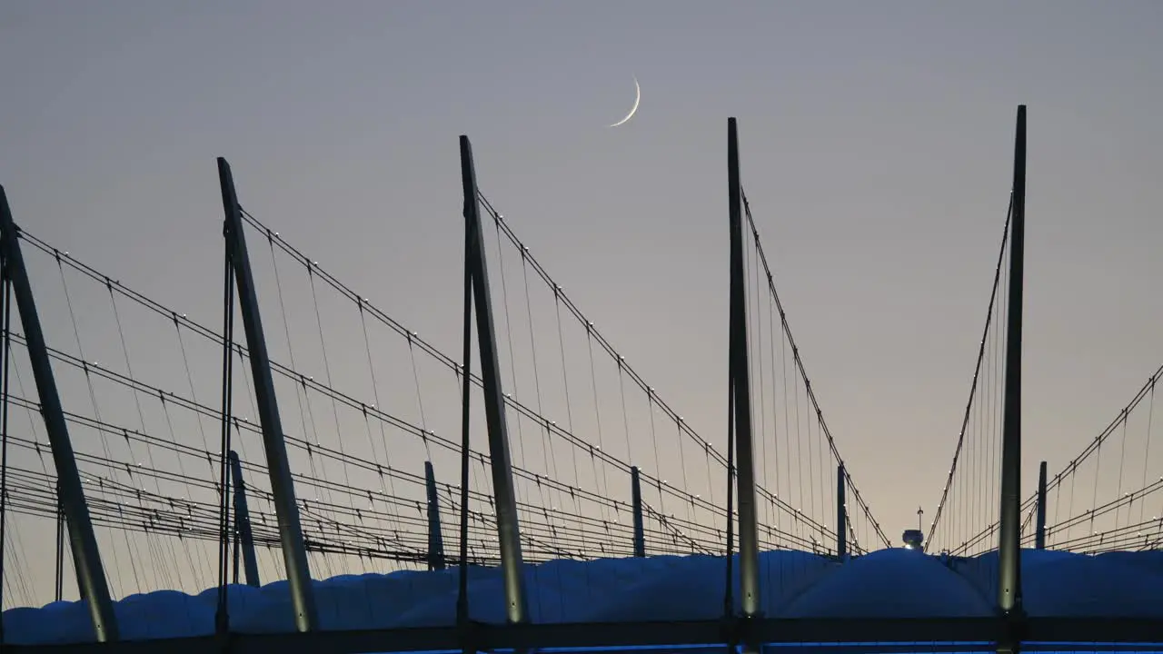 Crescent Moon Rising Above the Roof of the BC Place Stadium Close Up