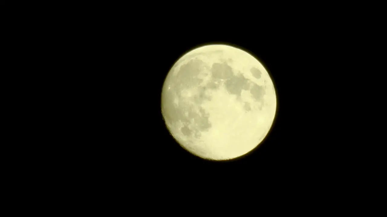 A moving full moon in the sky with details on the surface