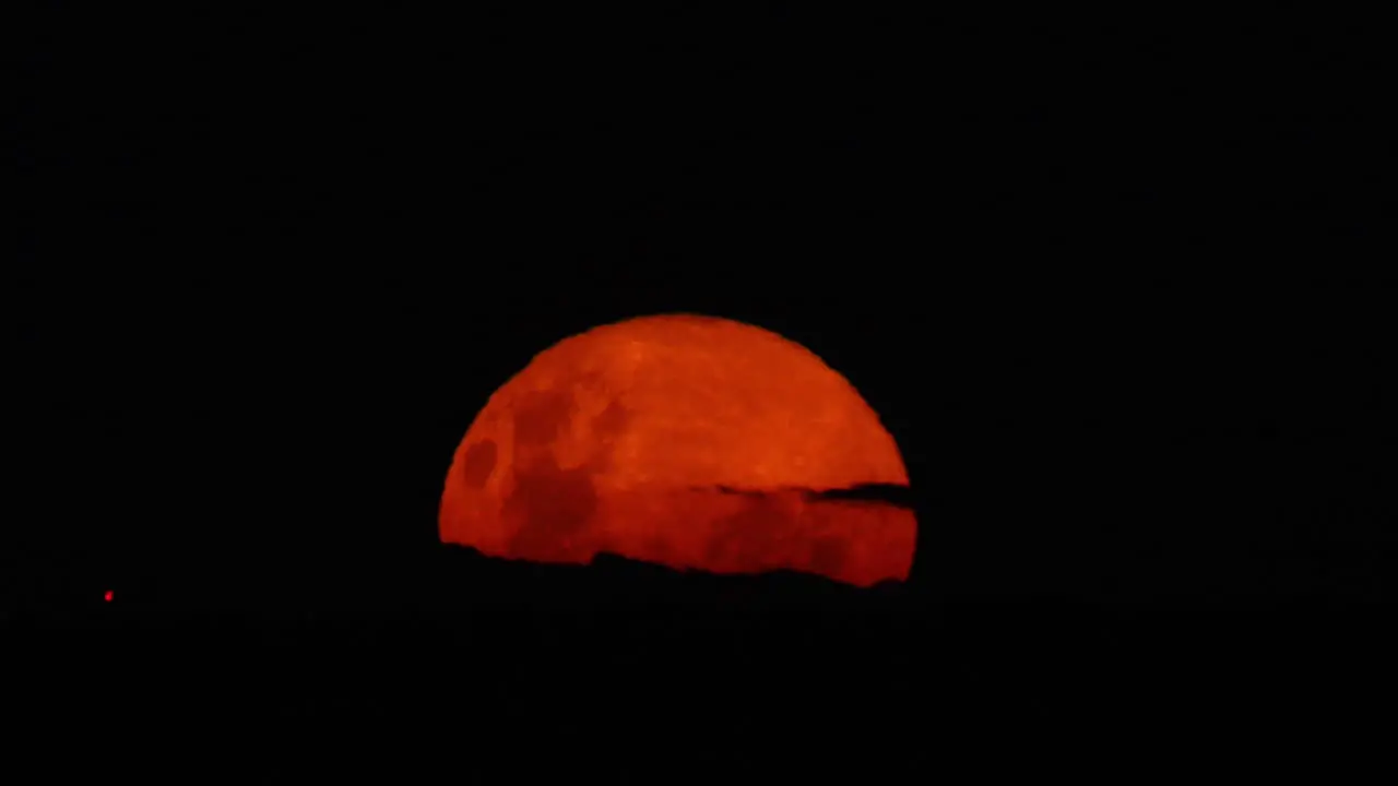 Full moon rising over the horizon blood moon super moon