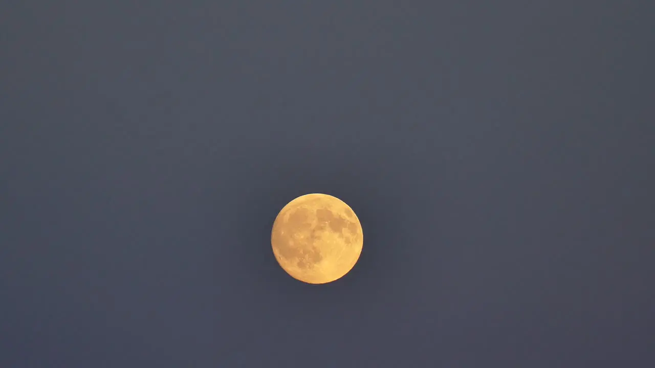 Full Moon Rising Over Grey Sky At Night