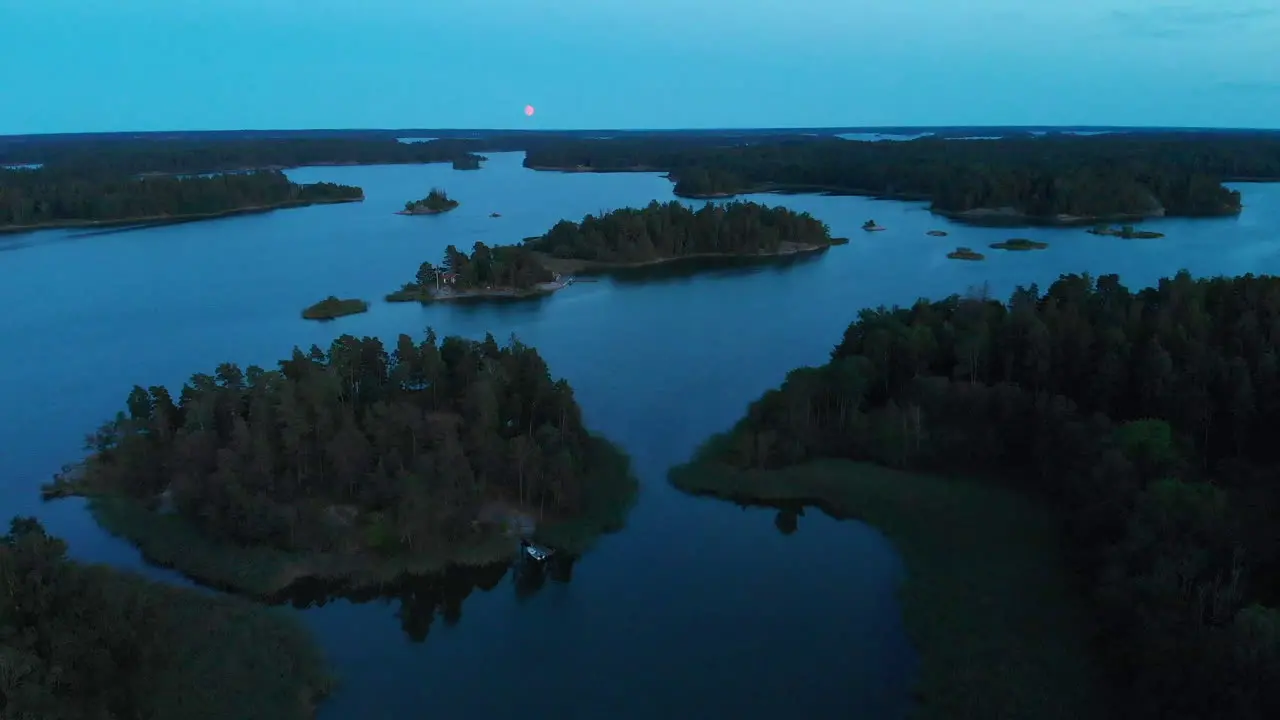 Moon rise over Scandinavian archipelago islands in 4k