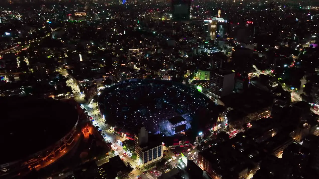 Aerial view around a rock band playing at a stadium in Mexico city circling drone shot