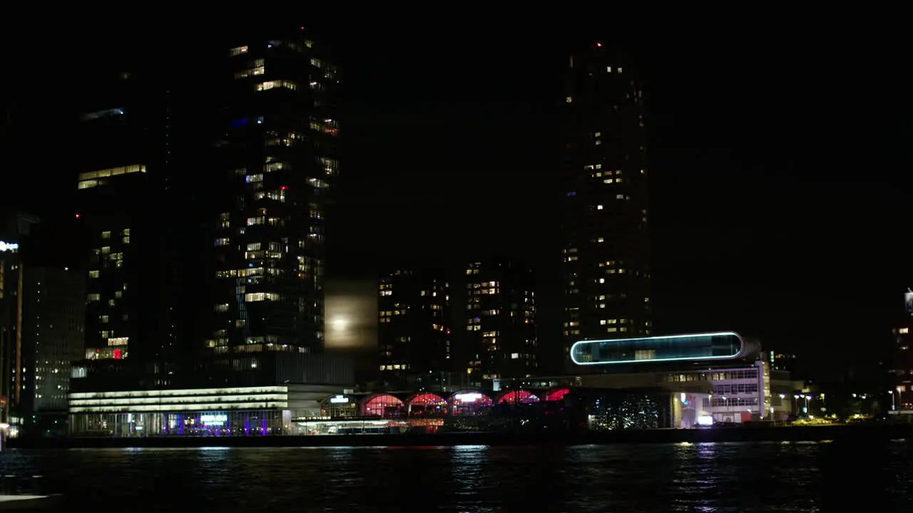 The skyline of Rotterdam during night time with a full moon