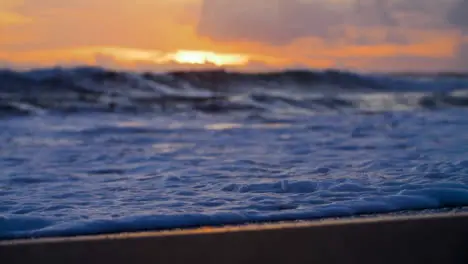 Handheld Close Up Shot of Waves On Echo Beach Shore at Sunset