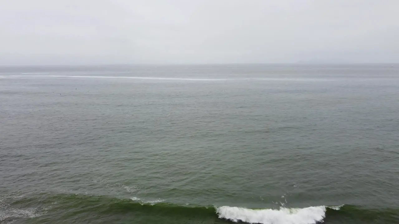 Person running towards cliff edge on ocean coast