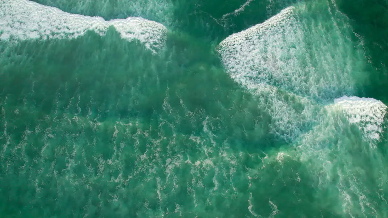 Aerial view of waves going towards beach