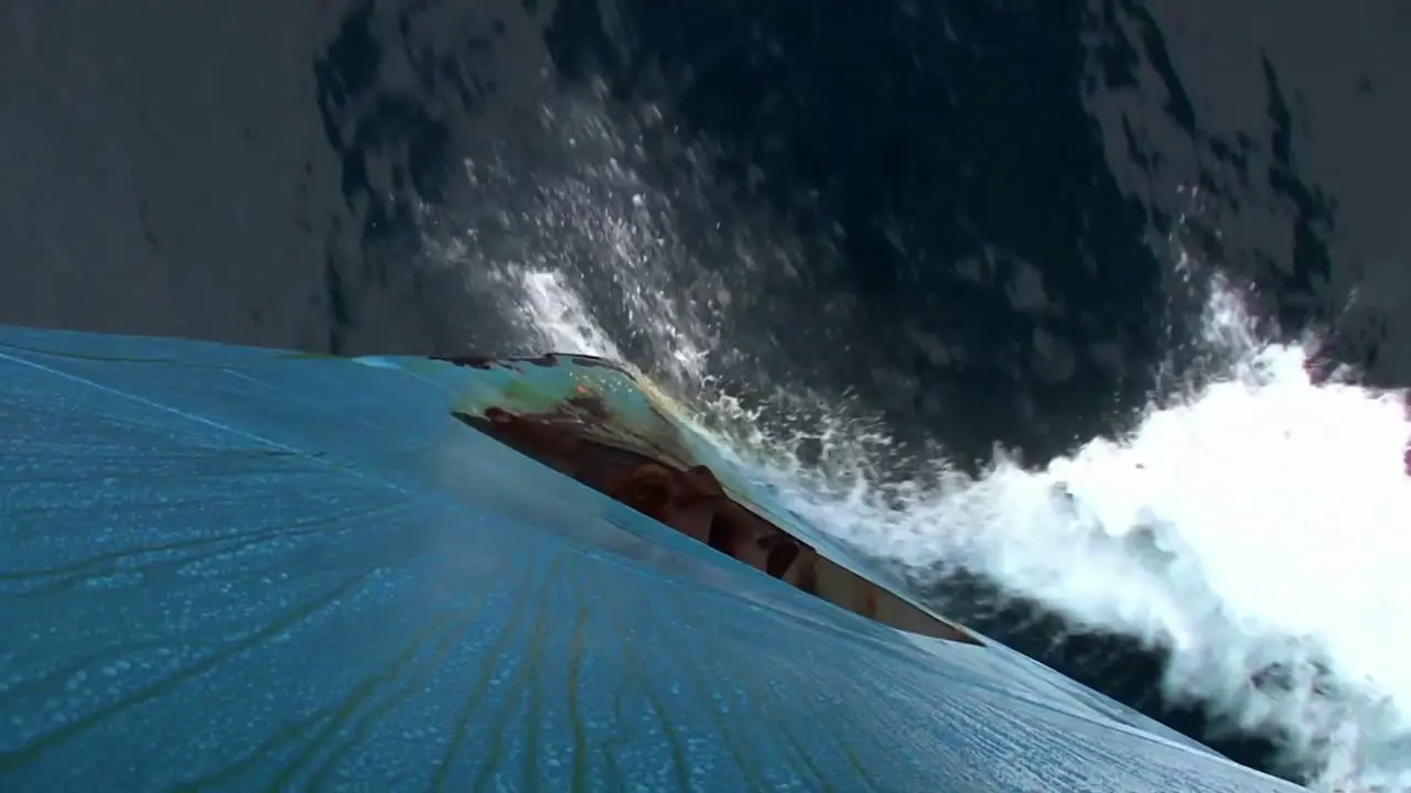 Artistic shot looking straight down from bow of ship to see ocean below with icebergs visible 1