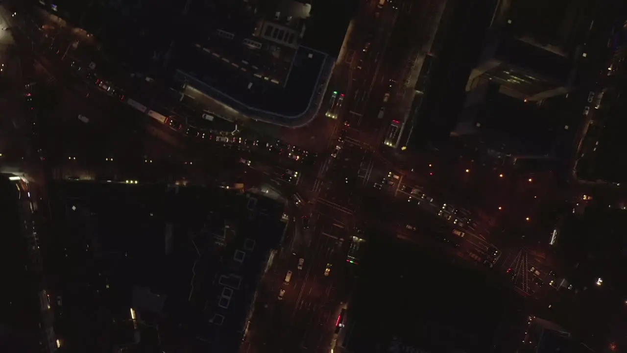 AERIAL Beautiful Overhead Shot of busy intersection at night with Car traffic and city lights