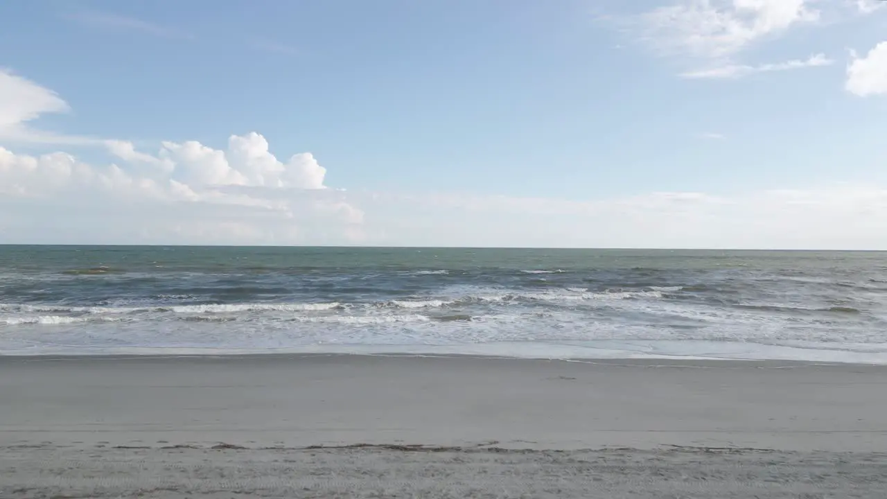 Drone Flying Over Top of Sand Dune Reveals Ocean