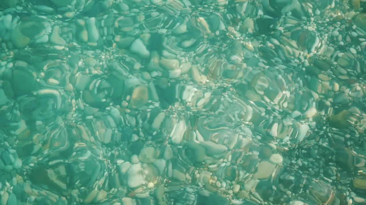 Through The Crystal Clear Sea Water You Can See A Variety Of Sea Stones On The Sea Coast