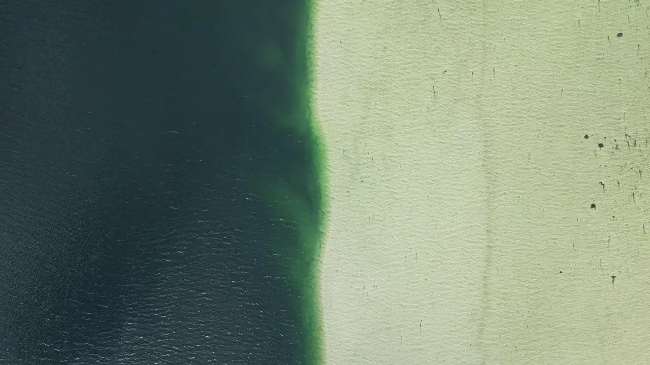 Aerial view of Barrier between fresh and salt water on the Lofoten Islands in Norway with a sweeping movement upwards revealing the surrounding landscape of mountains and fjords