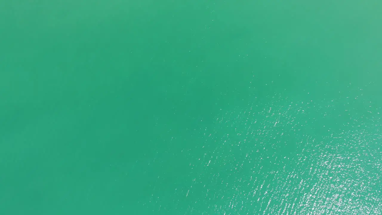 Top Down View Of Turquoise Water Of The Ocean aerial drone shot