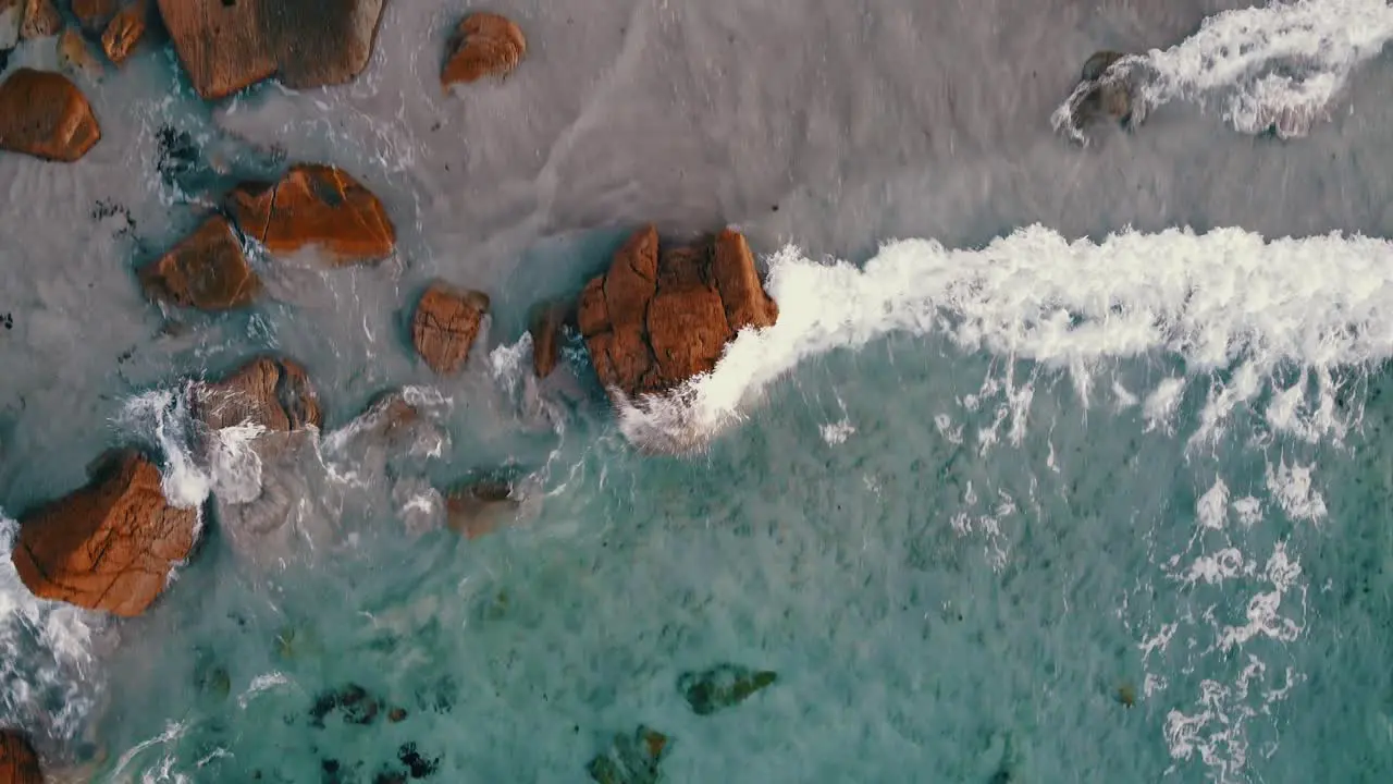 Top view aerial fly over crystal clear water from the ocean