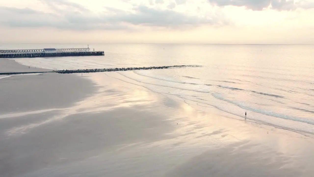 Beautiful White beach with reflecting sea in sunset with sober colors in Blankenberge belgium