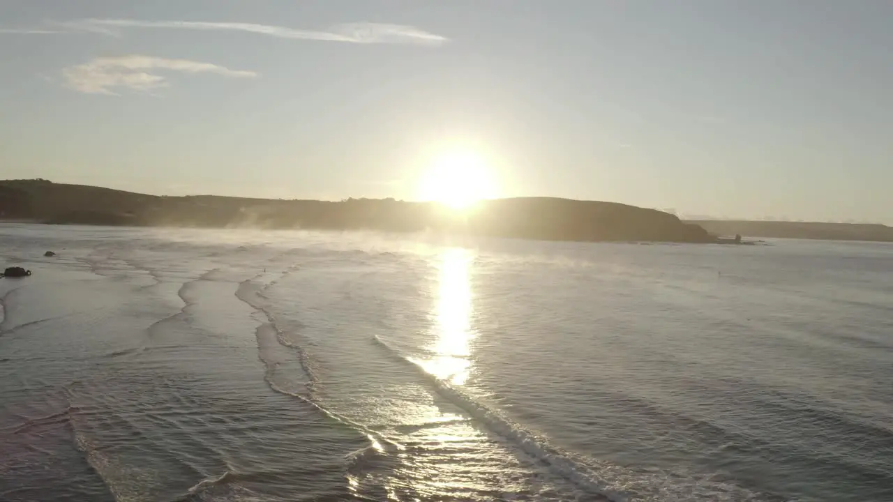 Panning Aerial Truck Shot of Bantham Beach at Sunrise with Steam rising off the ocean