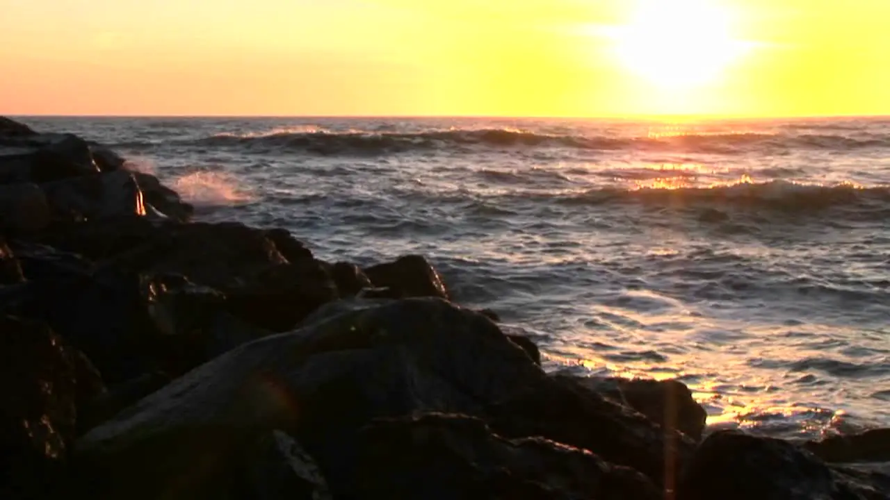 Ocean waves crash into rocks at sunset 2