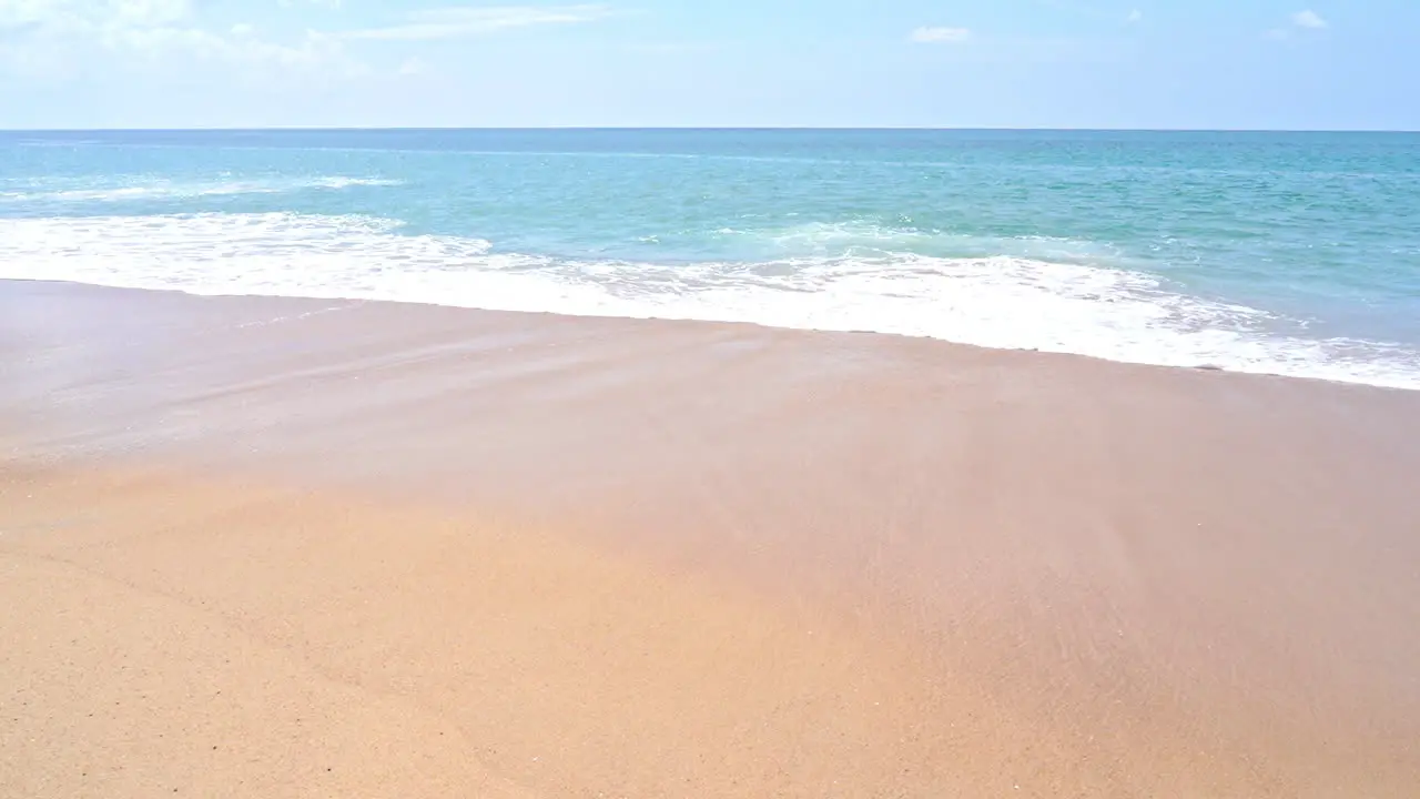 Slow-motion of waves sweeping across a sunny beach