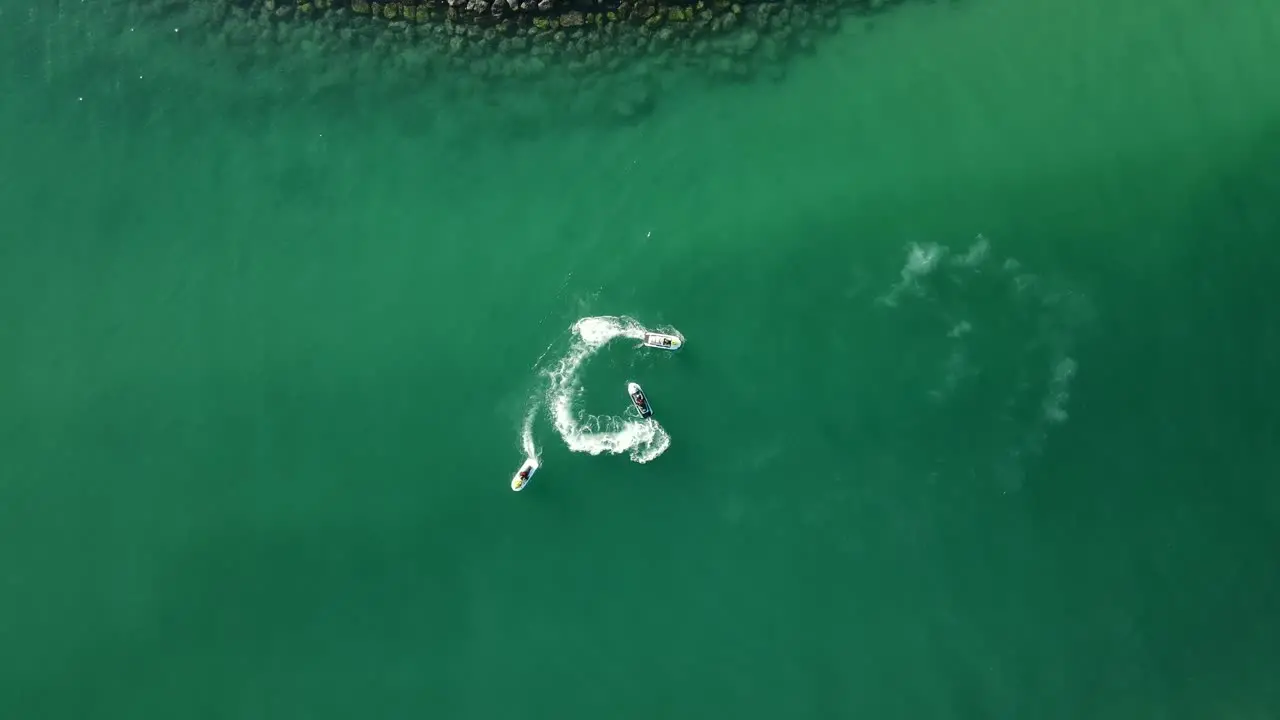 Top view of jet-skiing in coast blue-green crystal clear water of Dubai's Mamzar beach Arabian Sea top tourist attraction 4k Footage