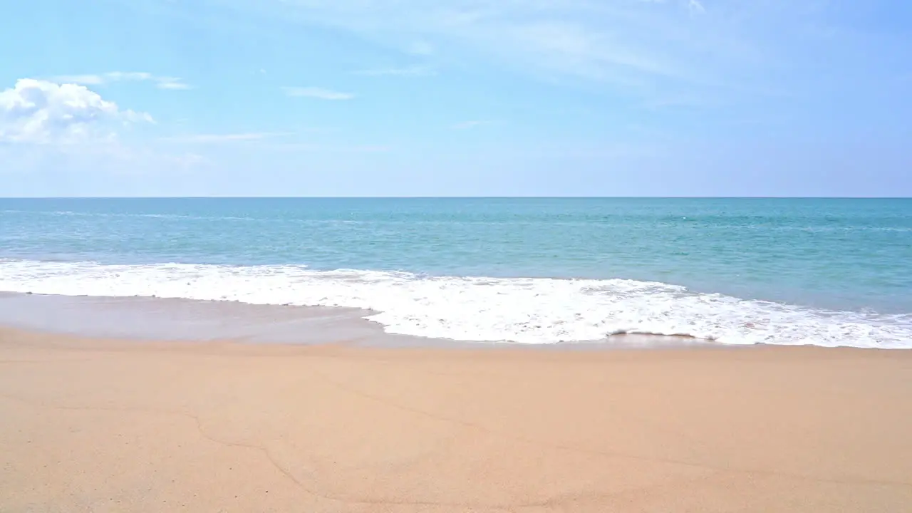 Slow-motion of large waves hitting the sands of a tropical beach