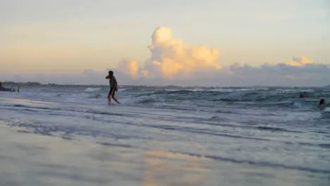 Wide Shot of Person Walking Out from Sea at Echo Beach