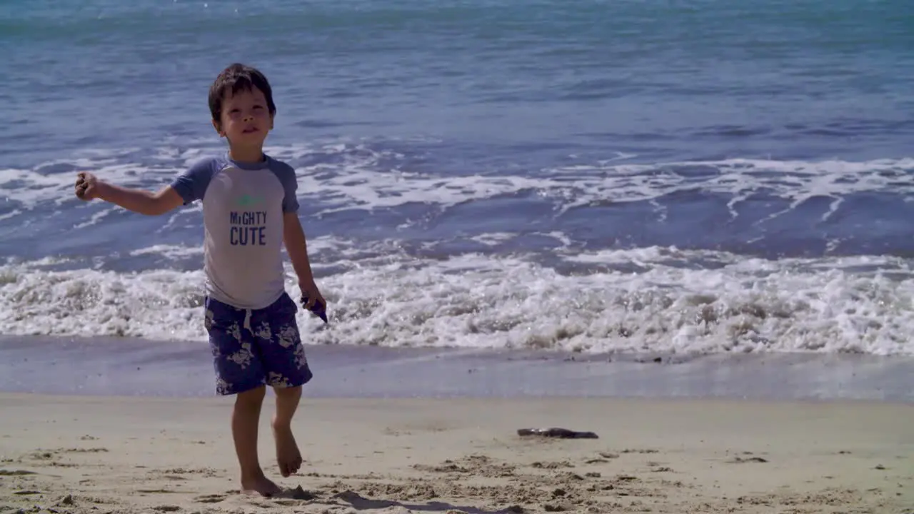 A boy plays and enjoys a day at a Mexican beach