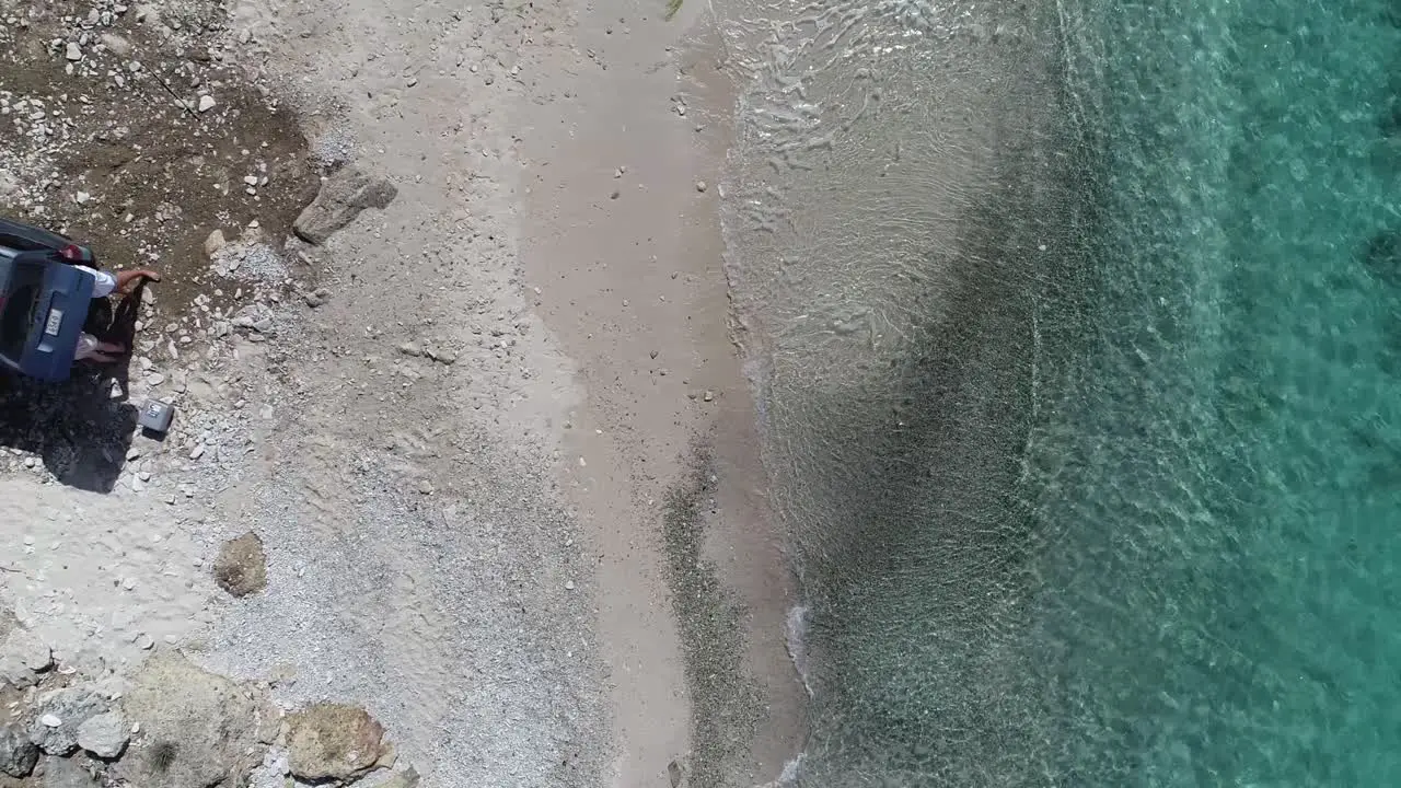 drone fllying from close to far beach view waves crashing