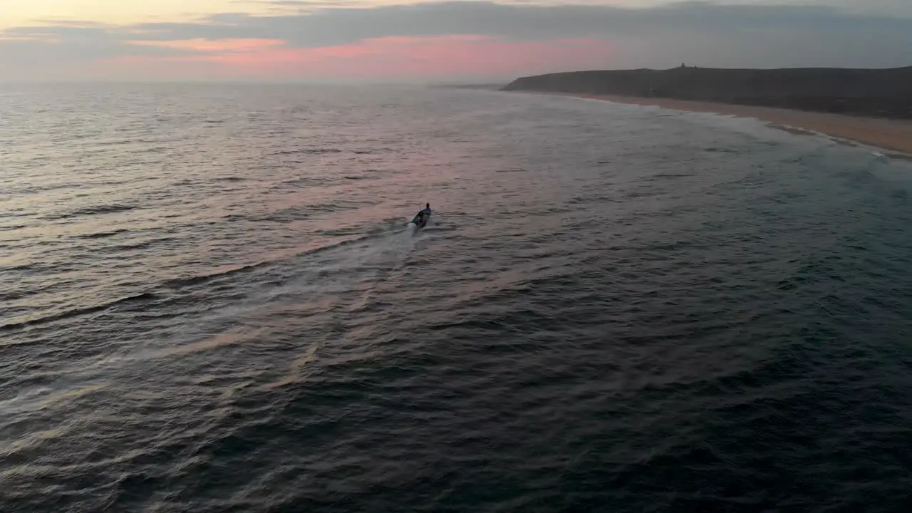 Small fishing boat at sunset in rural Mexico ocean drone establishing shot 4k