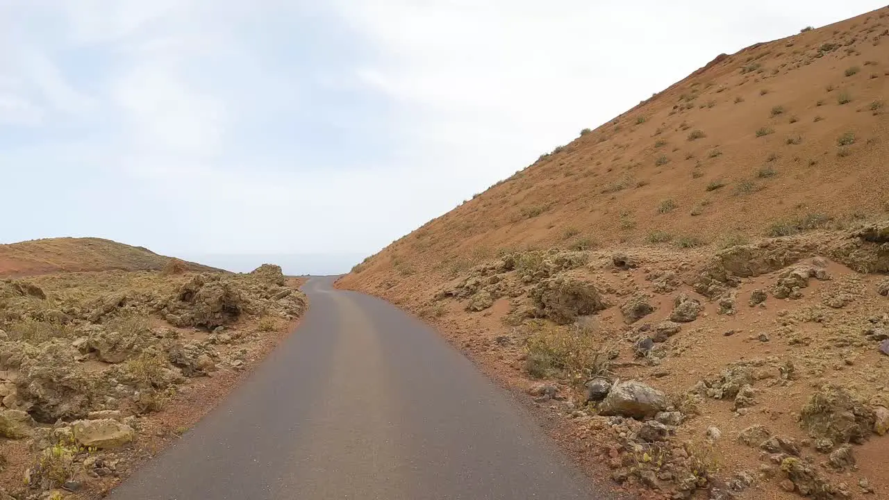 timanfaya images from the road volcanic natural park of Lanzarote driving on the road point of view from the front of the car