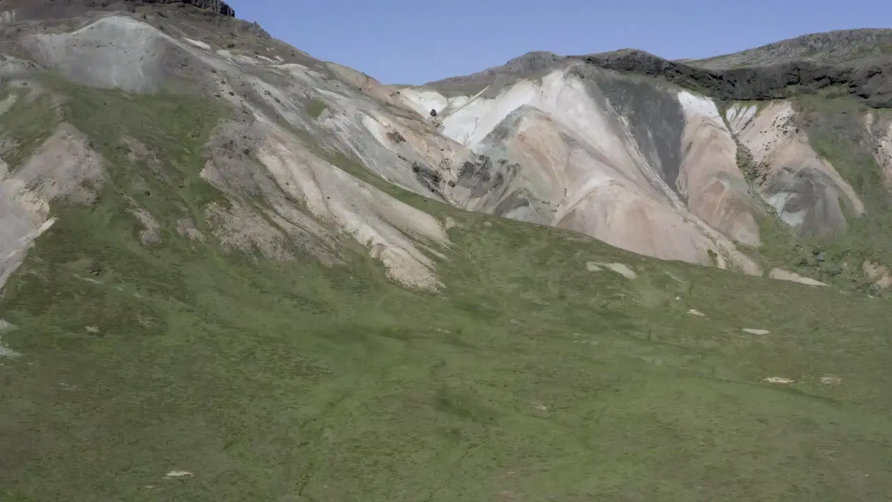 Rough surface of mountainside showing several layers of earth by erosion aerial