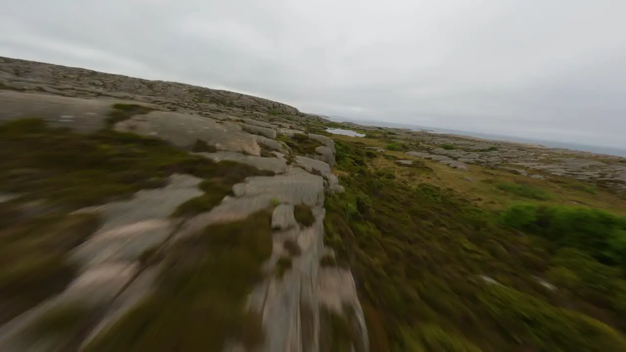 FPV drone flight by an edge of a cliff in Ramsvik Sweden