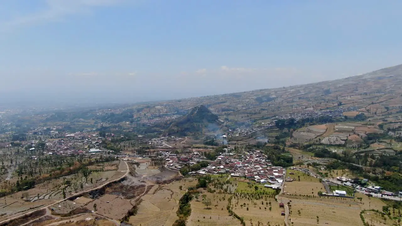 Small villages situated near mountain base in Indonesia aerial view