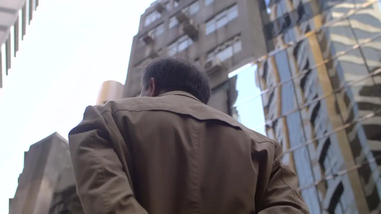 Man Surrounded by Hong Kong Skyscrapers