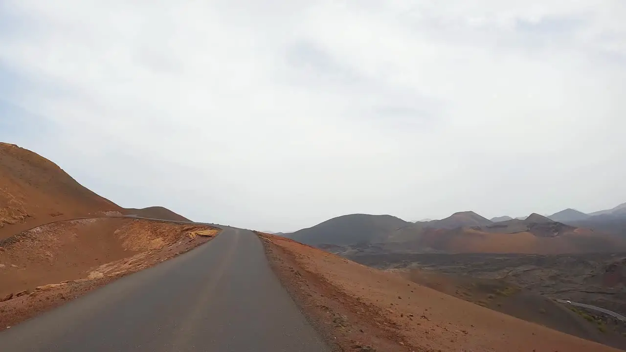 timanfaya images from the road volcanic natural park of Lanzarote driving on the road point of view from the front of the car lunar landscape