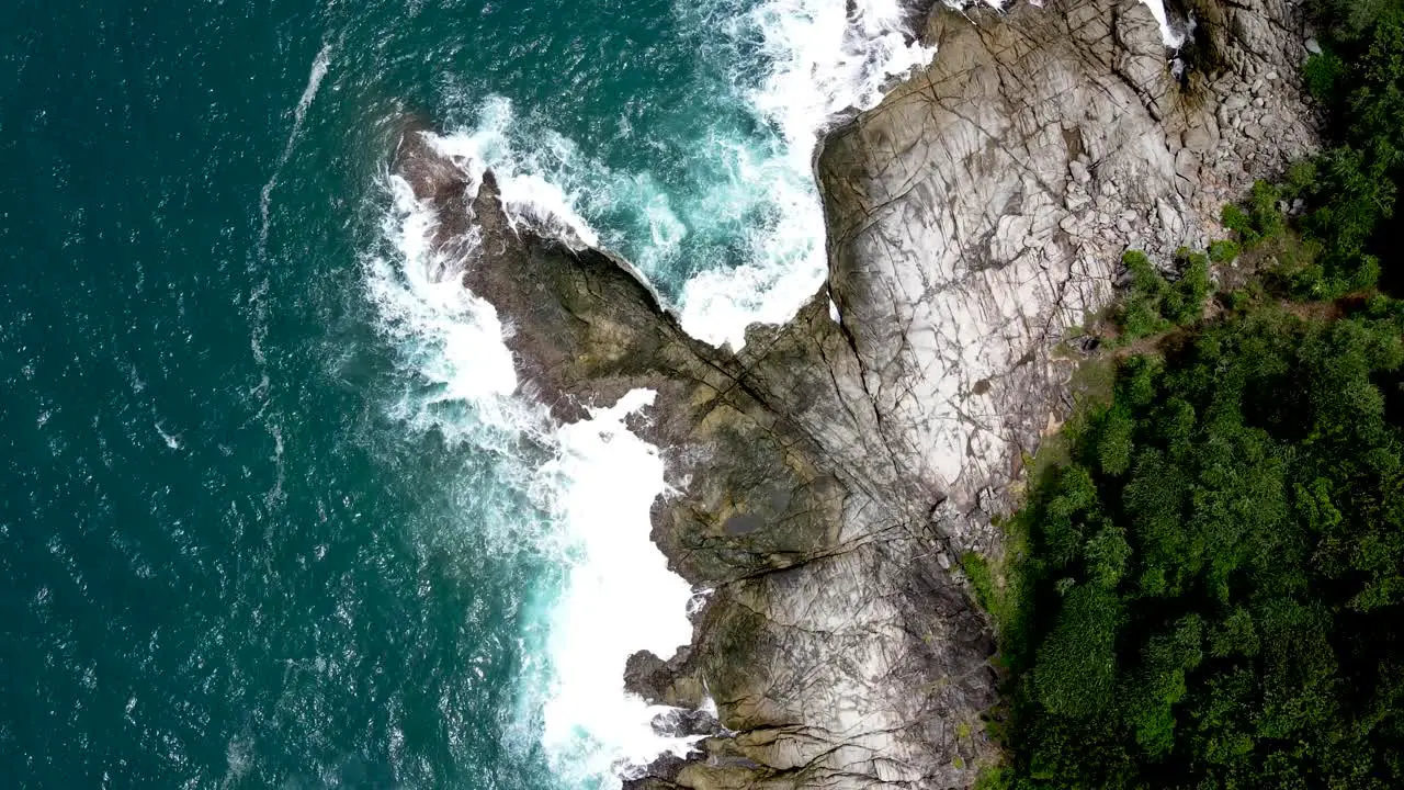 Aerial Birds Eye View Over Waves Breaking On Coastline Rocks In Phuket