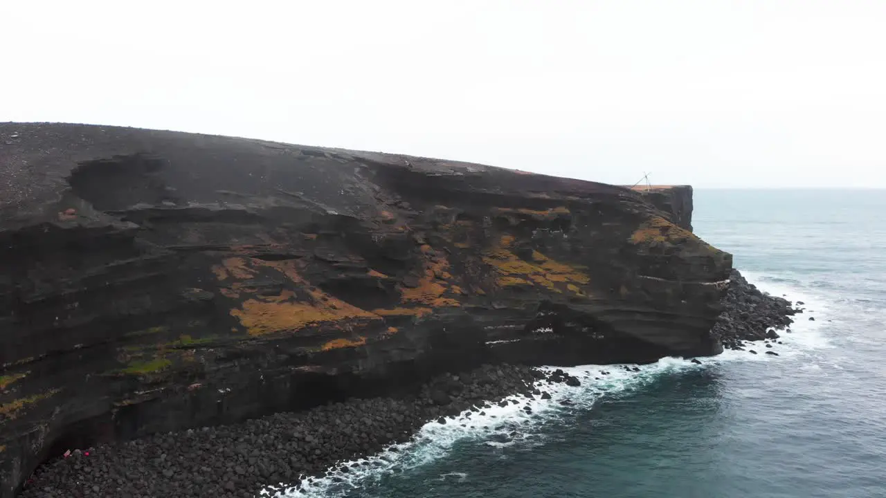 Black volcanic Krísuvíkurberg cliffs of cold lava on coast of Iceland