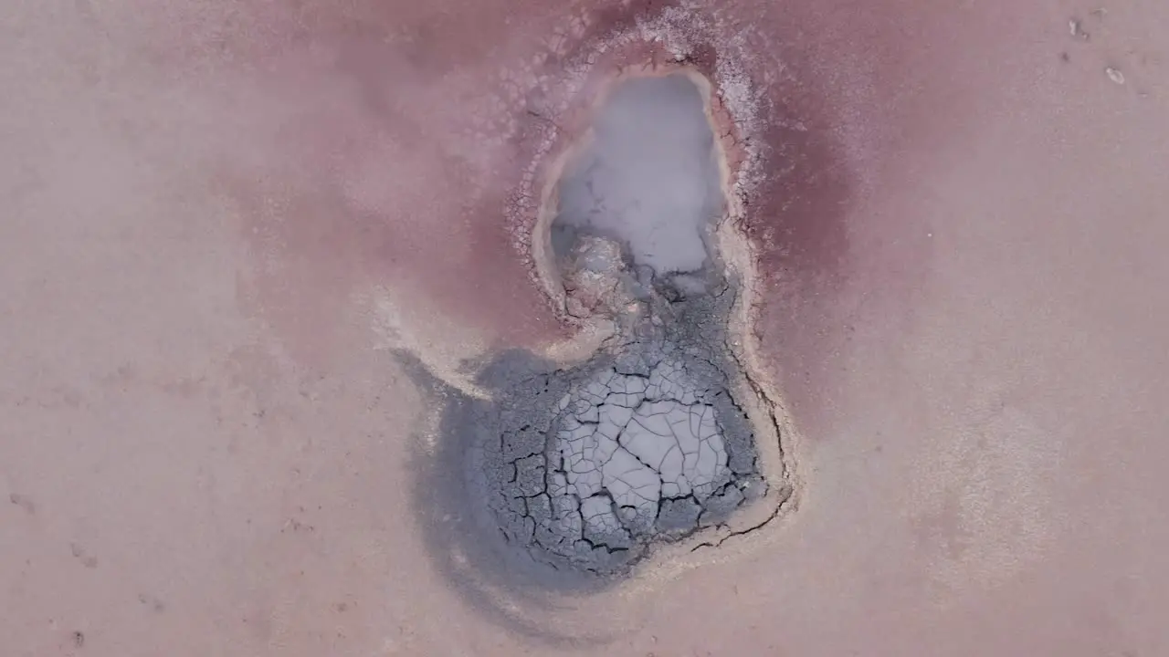 Acidic mudpot with sulphur vapor coming from volcanic activity aerial