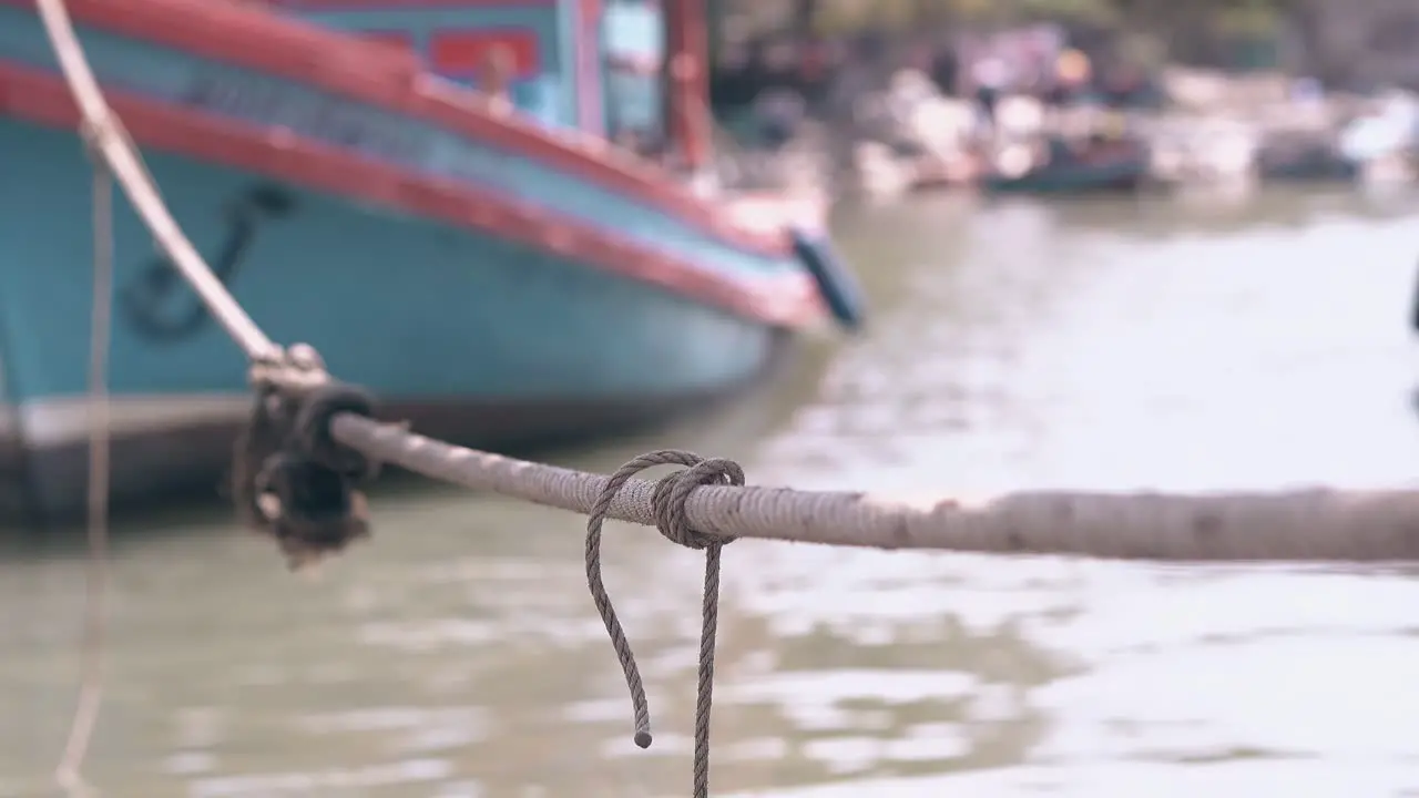 ship rope connects fishing boat with moor close view