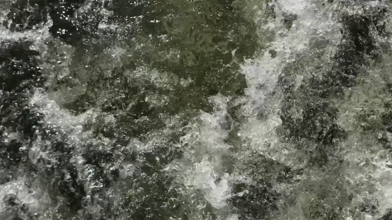 Close up view of the swirling green river water created by the power of an outboard motor