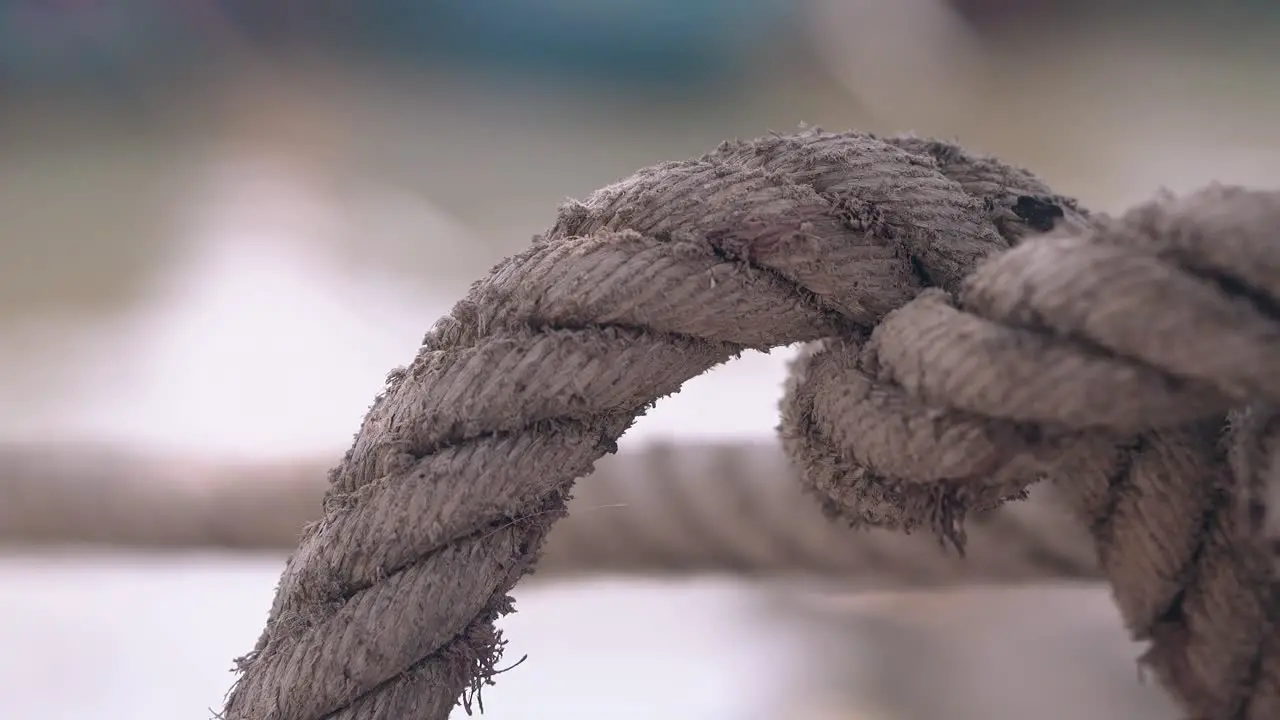 knot on ship rope connected with fishing boat over water