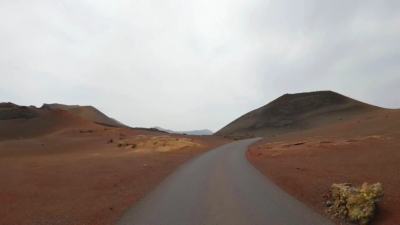 timanfaya volcanic natural park of Lanzarote driving on the road point of view from the front of the car lunar landscape