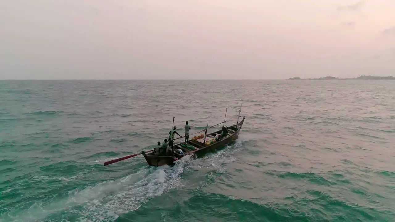 Drone chasing a canoe to the port