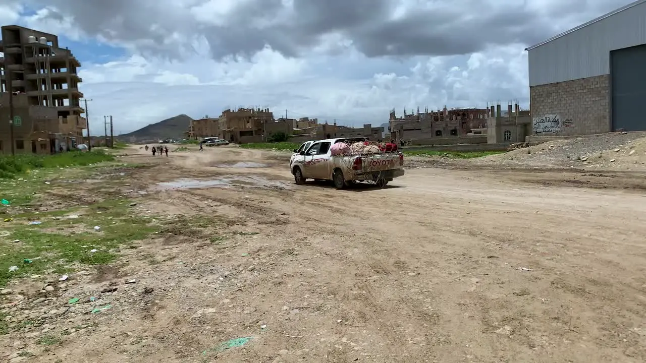 Qat merchant drive through rough street to get to the market in time Yemen sana'a