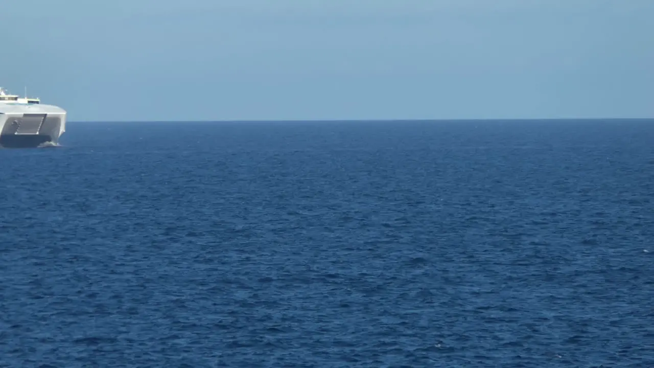 Fast Ferry of the Balearia in the middle of the sea arriving near Ciutadella in Menorca during summer 2021