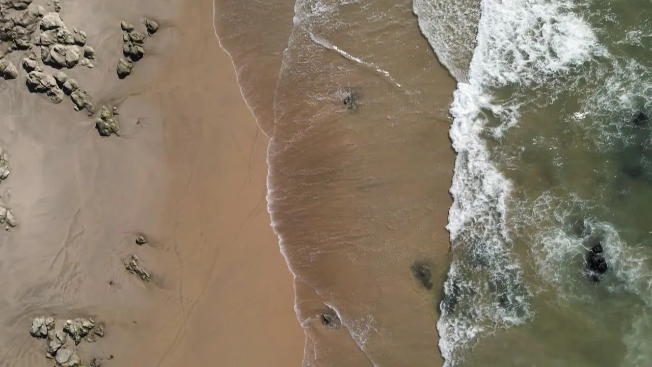 Top down view of a empty beach with rocks