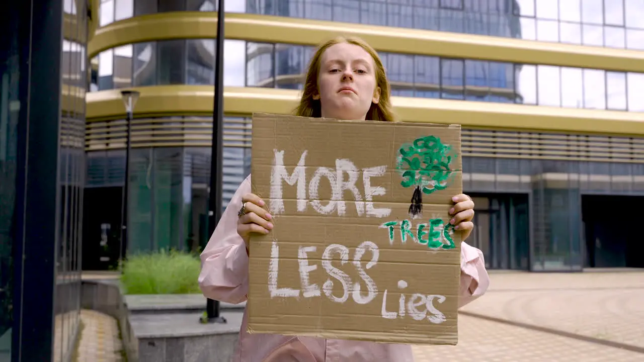 Cute Redhead Holding A Placard And Protesting 1