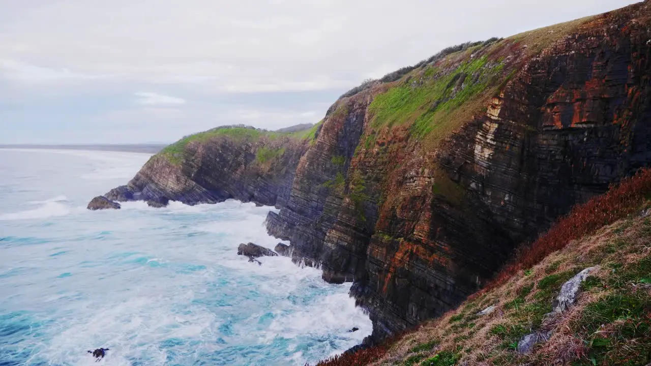 Waves splashing on the rocky mountainside Crescent Head NSW Australia