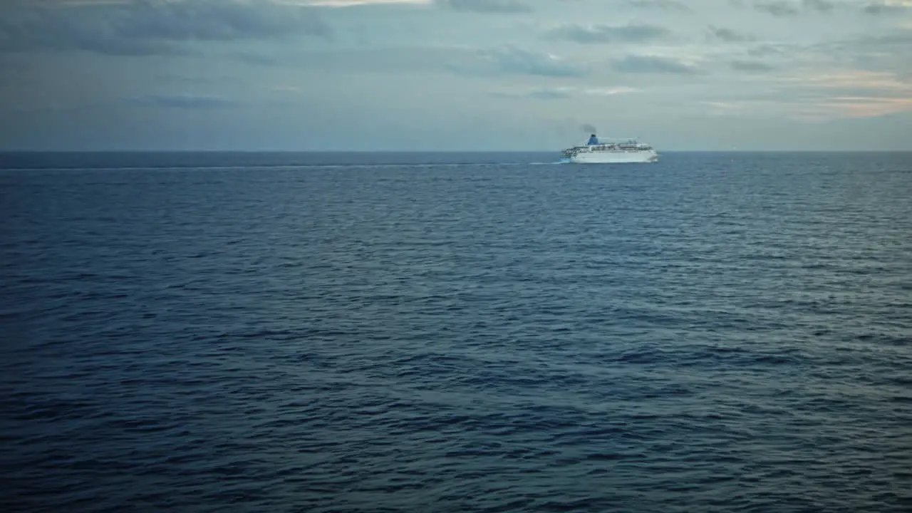 Cruise ship in ocean with small waves and in a distance