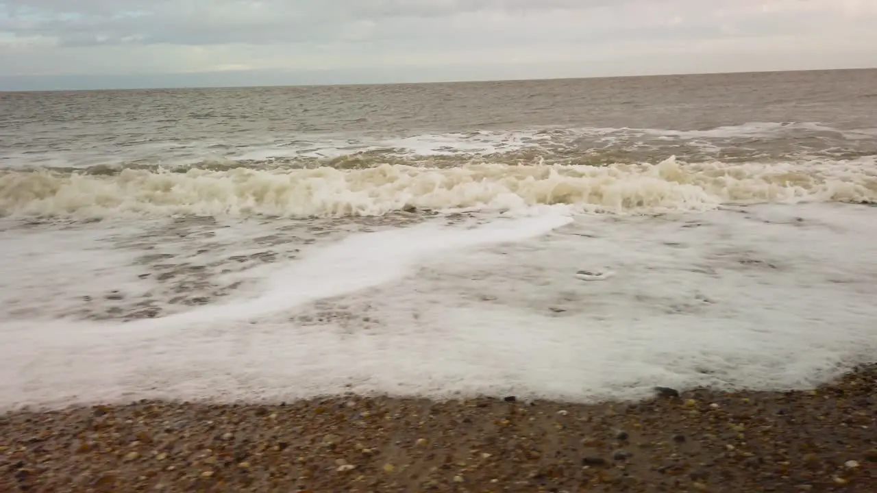 Thick foamy polluted dirty waters of Norfolk Great Yarmouth North Sea