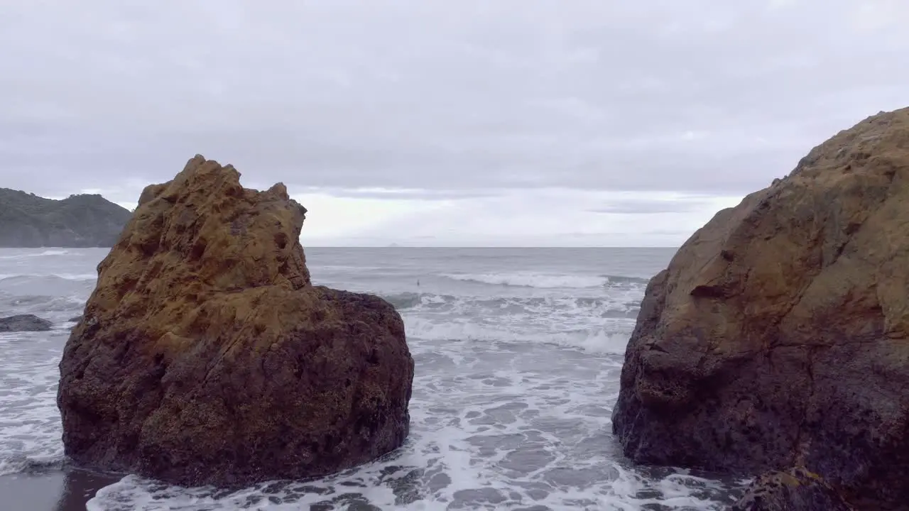 Remote hidden beach on wild east coast of New Zealand on cloudy day aerial