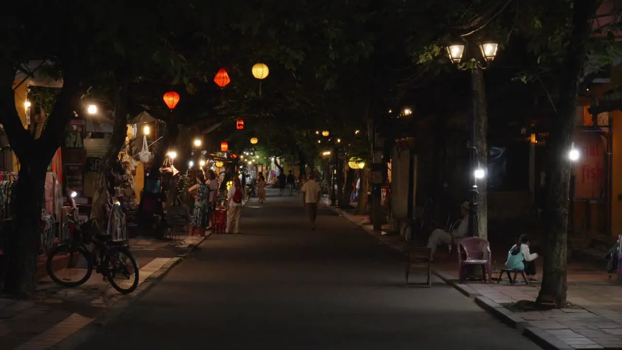 A static nighttime shot of the pedestrian street in the old town of Hoi An Vietnam